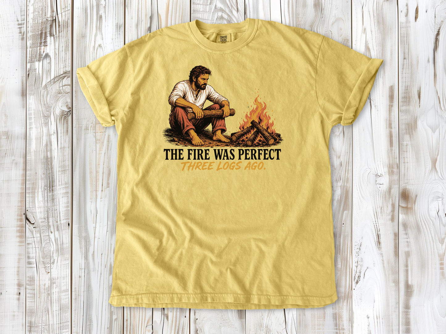 Grey garment-dyed tee with The Fire Was Perfect Three Logs Ago beach bonfire graphic.