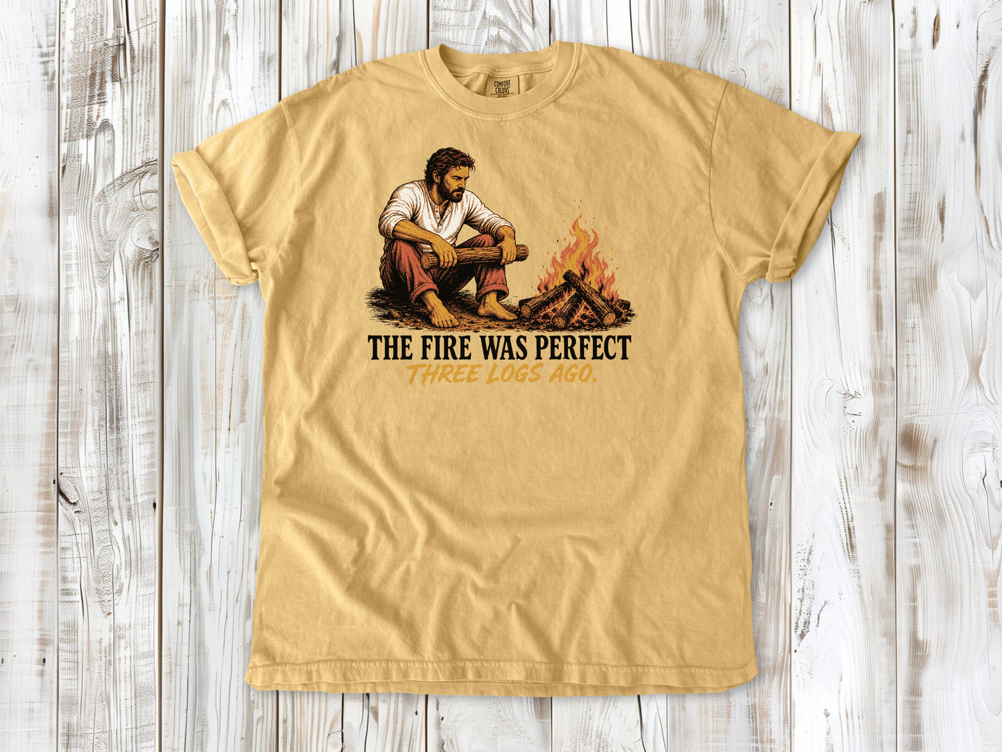 Burnt Orange garment-dyed tee with The Fire Was Perfect Three Logs Ago beach bonfire graphic.