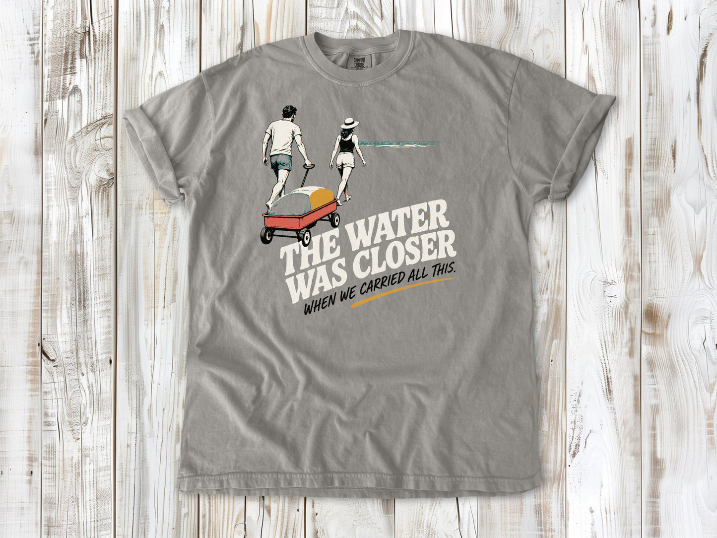 Khaki garment-dyed tee with The Water Was Closer When We Carried All This beach graphic.