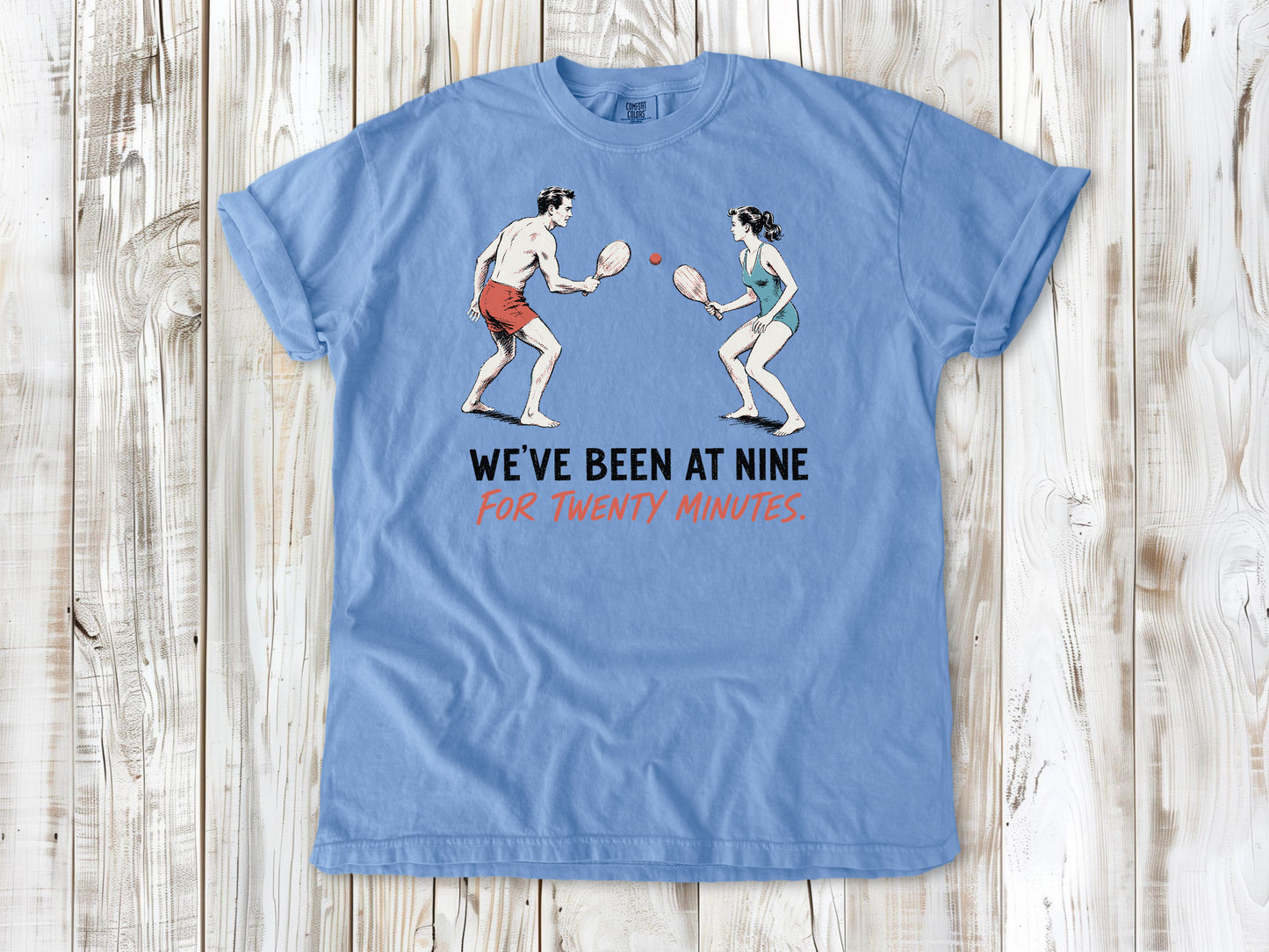 Pepper garment-dyed tee with We've Been at Nine for Twenty Minutes beach paddleball graphic.