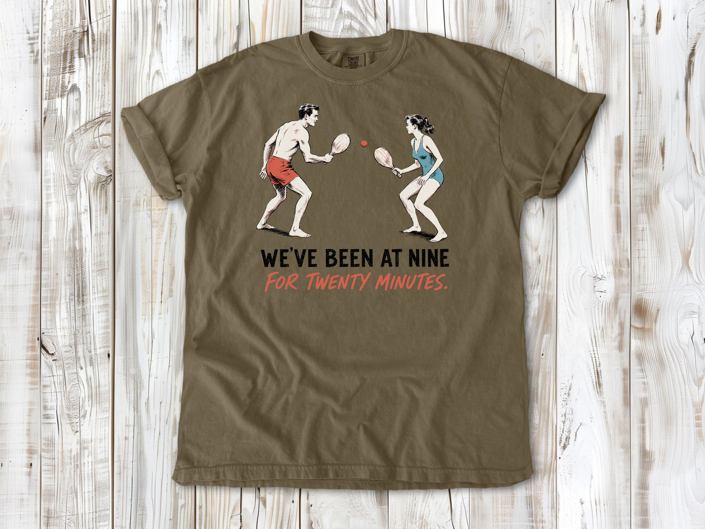 Graphite garment-dyed tee with We've Been at Nine for Twenty Minutes beach paddleball graphic.