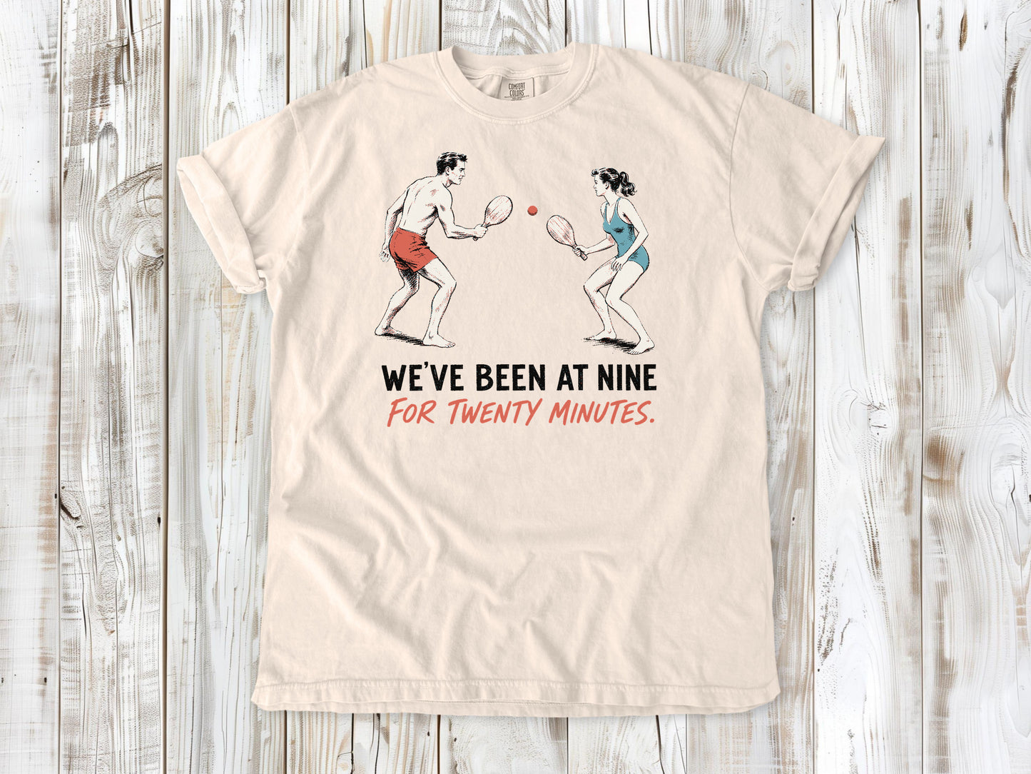 Butter garment-dyed tee with We've Been at Nine for Twenty Minutes beach paddleball graphic.