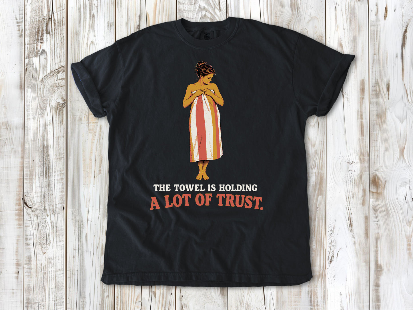 Washed Denim garment-dyed tee with The Towel Is Holding a Lot of Trust beach graphic.