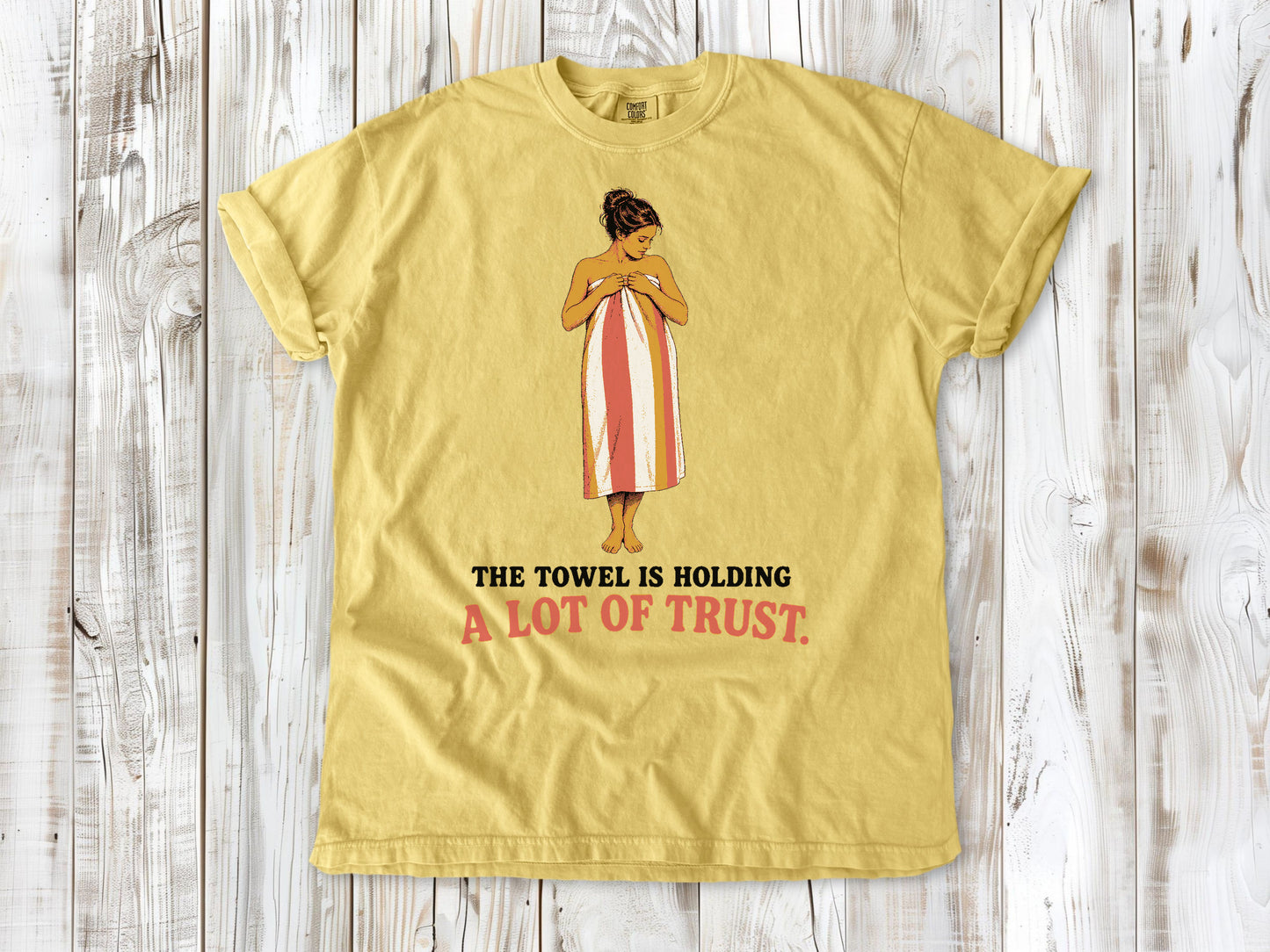 Grey garment-dyed tee with The Towel Is Holding a Lot of Trust beach graphic.