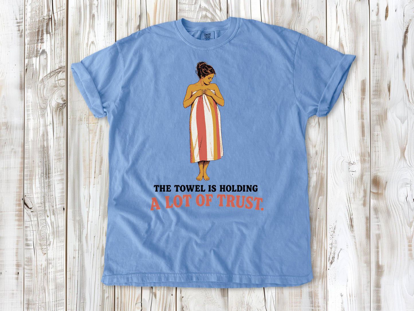 Pepper garment-dyed tee with The Towel Is Holding a Lot of Trust beach graphic.