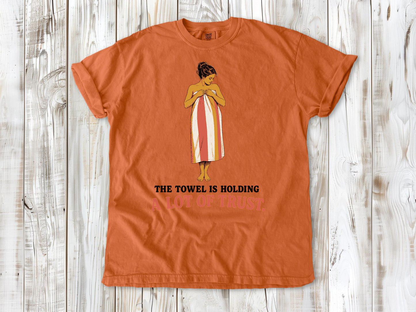 Seafoam garment-dyed tee with The Towel Is Holding a Lot of Trust beach graphic.