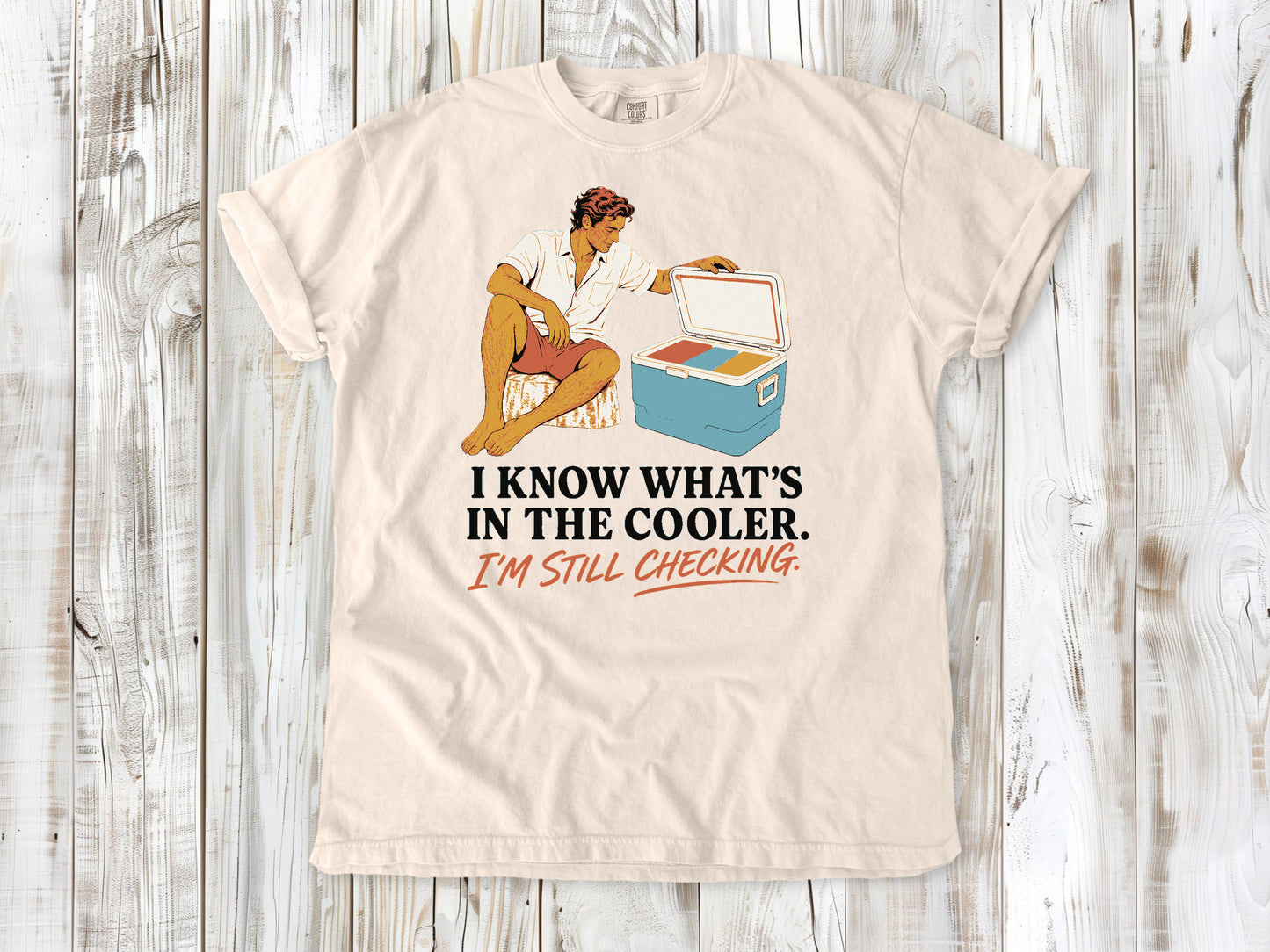Butter garment-dyed tee with I Know What's in the Cooler I'm Still Checking beach graphic.