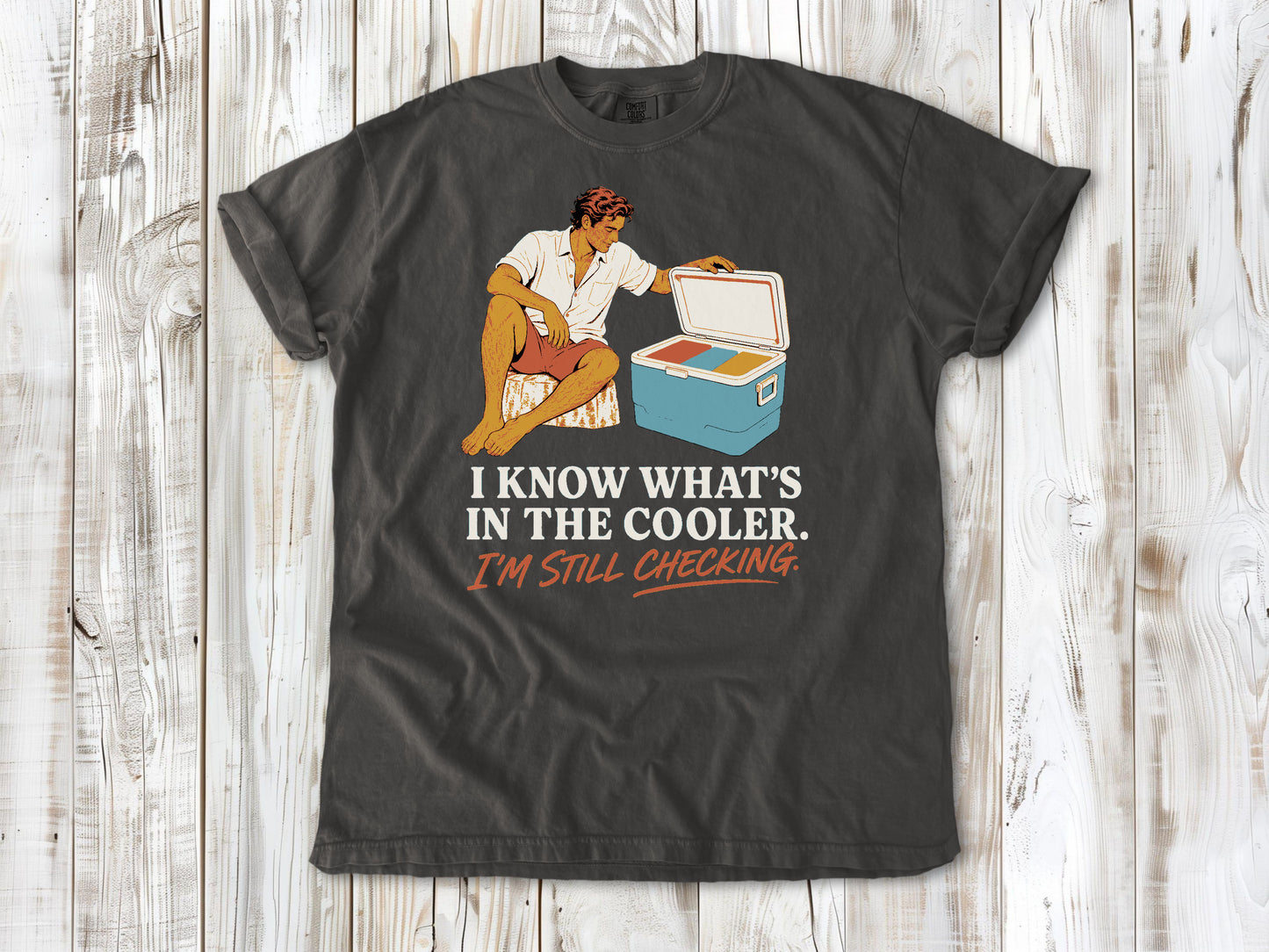 Ivory garment-dyed tee with I Know What's in the Cooler I'm Still Checking beach graphic.