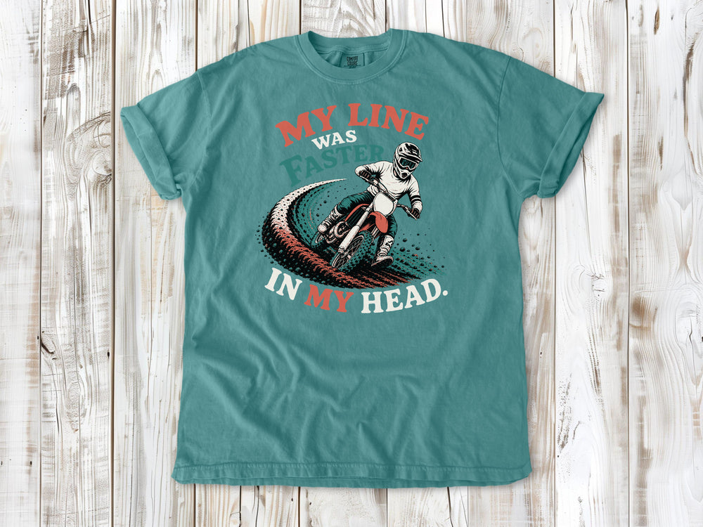 Seafoam garment-dyed tee with My Line Was Faster in My Head motocross rider graphic.
