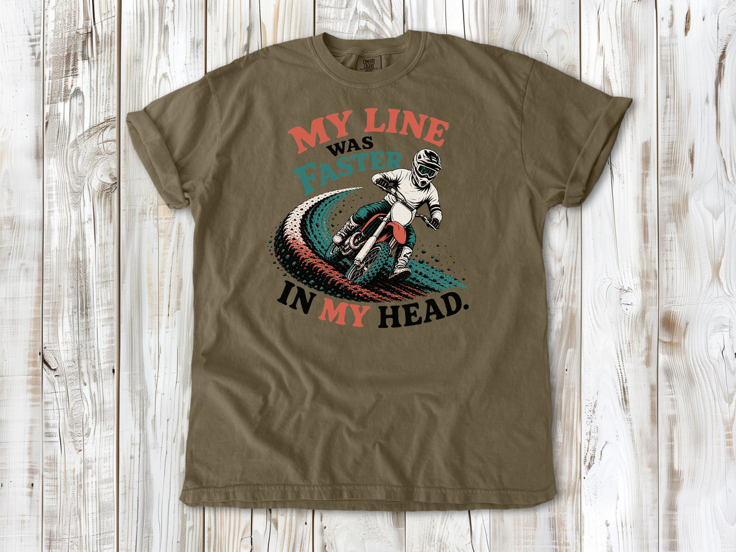 Khaki garment-dyed tee with My Line Was Faster in My Head motocross rider graphic.