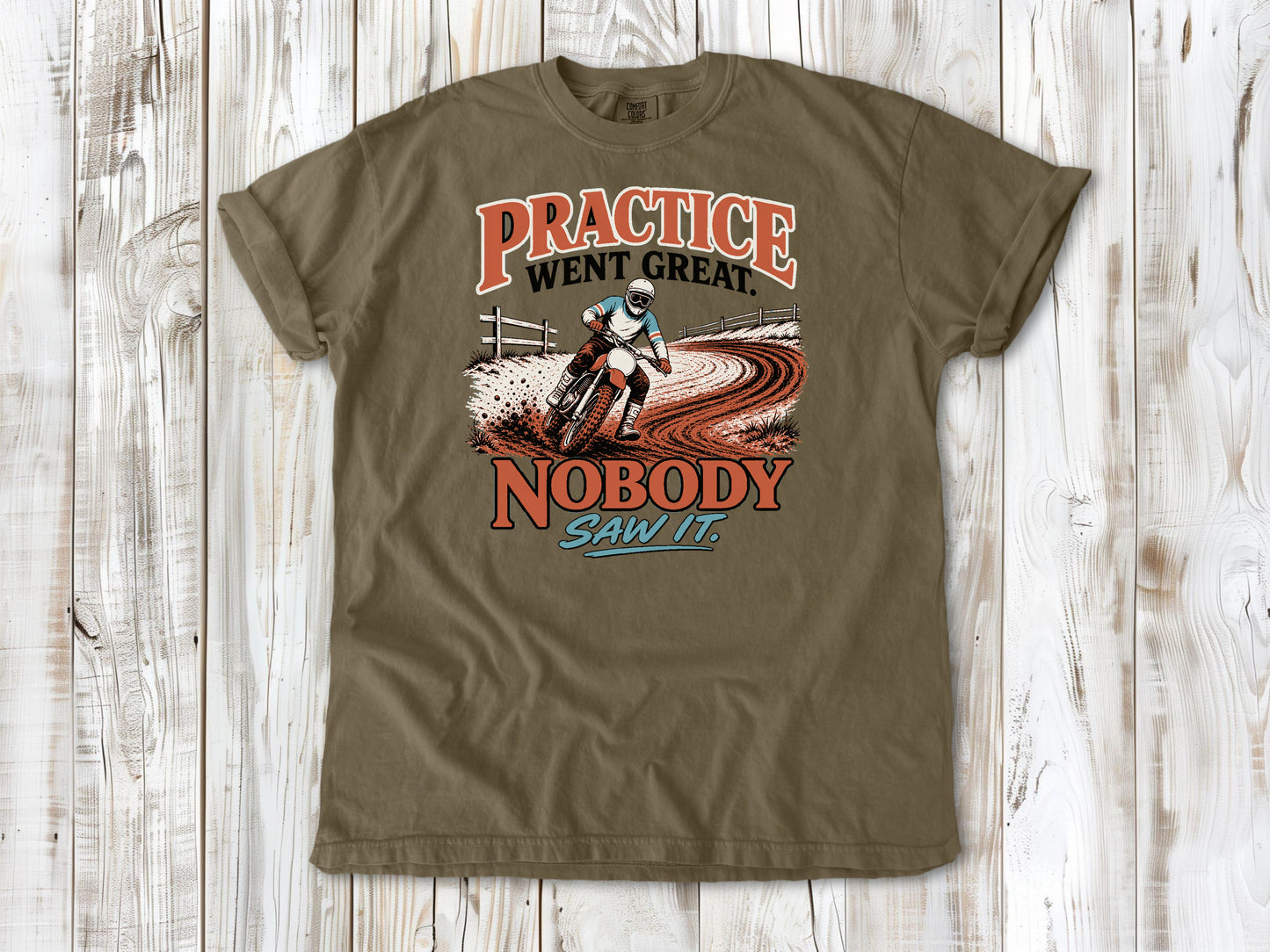 Khaki garment-dyed tee with Practice Went Great Nobody Saw It motocross graphic.