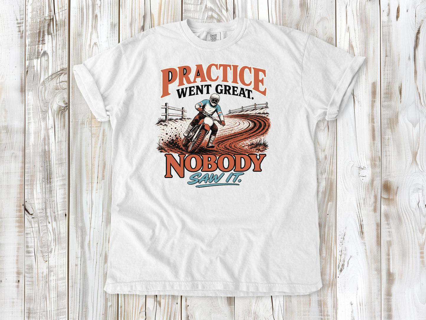 White garment-dyed tee with Practice Went Great Nobody Saw It motocross graphic.