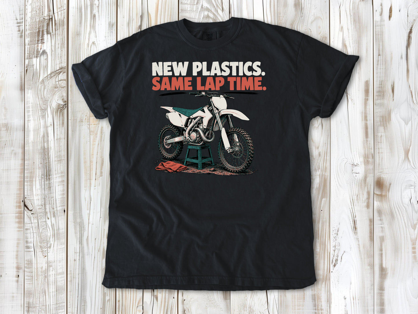 Graphite garment-dyed tee with New Plastics Same Lap Time dirt bike graphic.