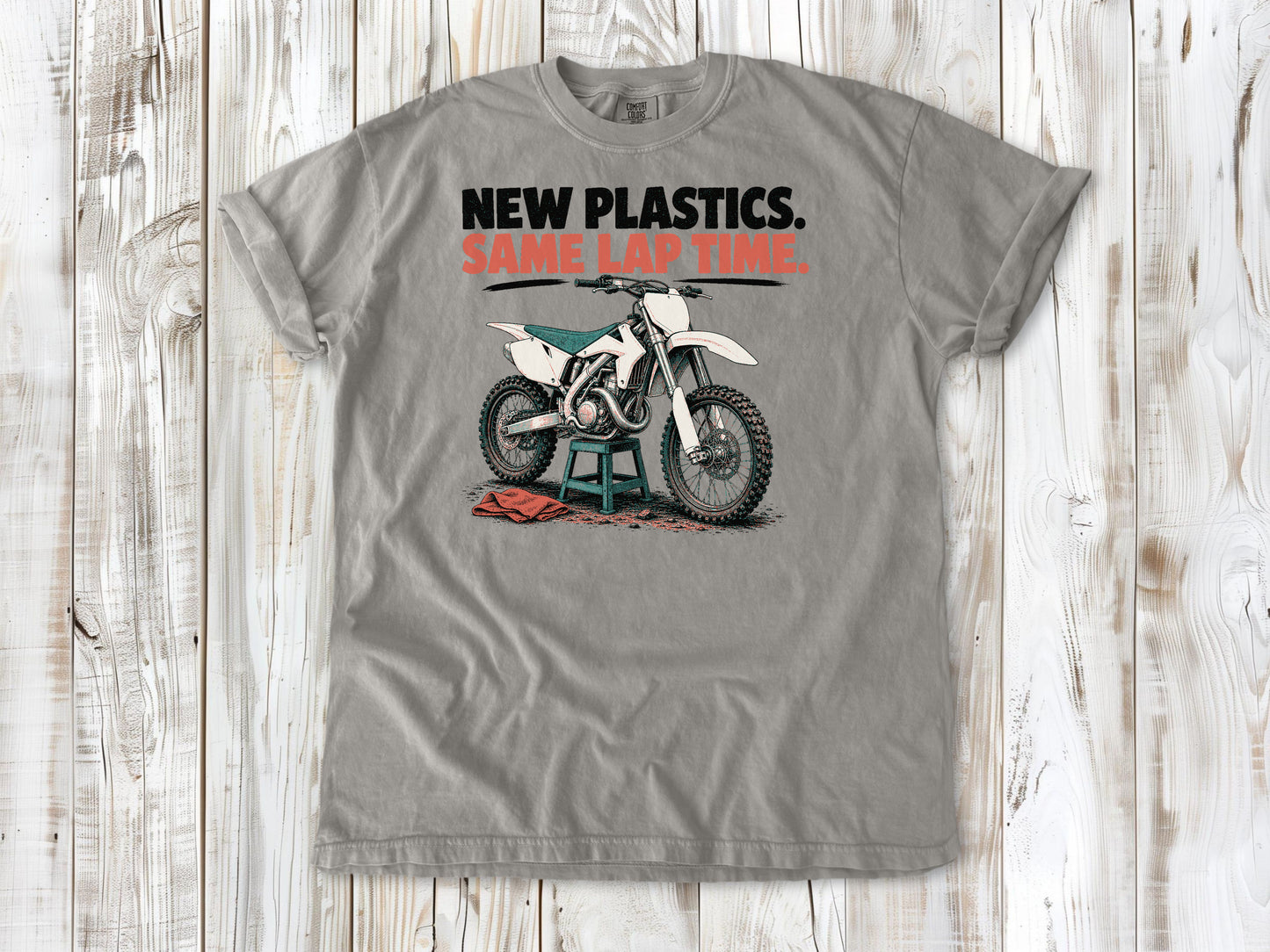 Grey garment-dyed tee with New Plastics Same Lap Time dirt bike graphic.