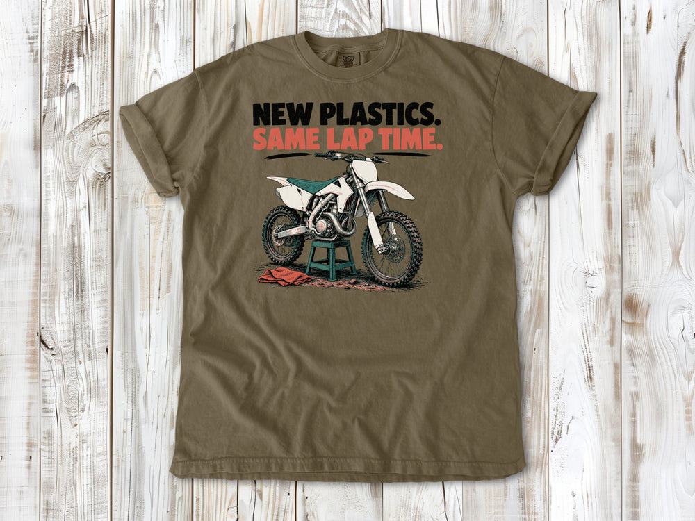 Khaki garment-dyed tee with New Plastics Same Lap Time dirt bike graphic.
