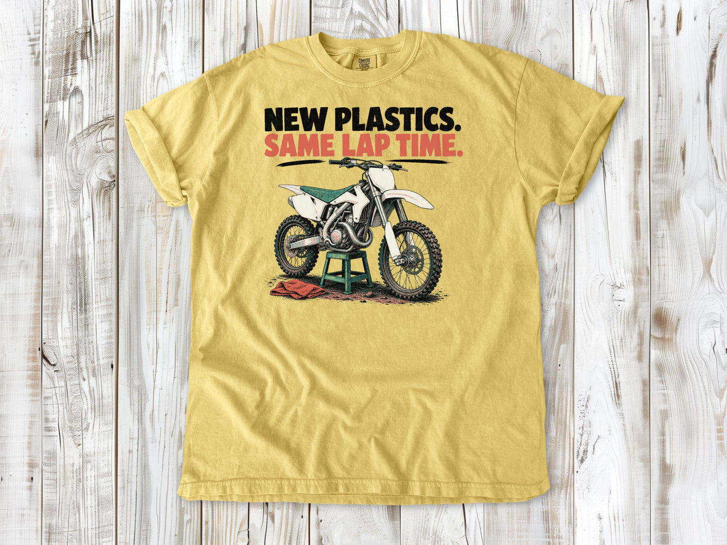 Butter garment-dyed tee with New Plastics Same Lap Time dirt bike graphic.