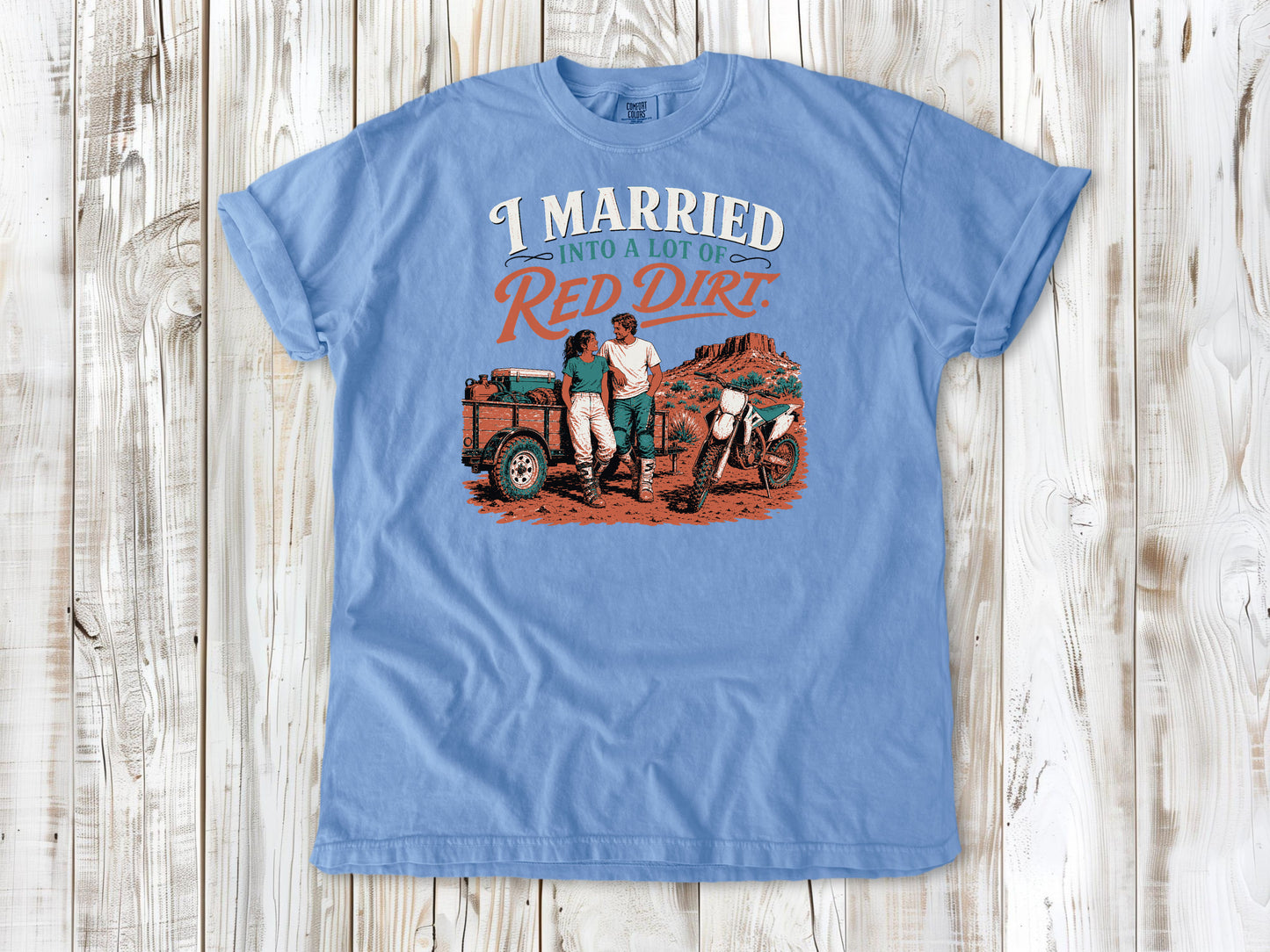 Washed Denim garment-dyed tee with I Married Into a Lot of Red Dirt motocross couple graphic.