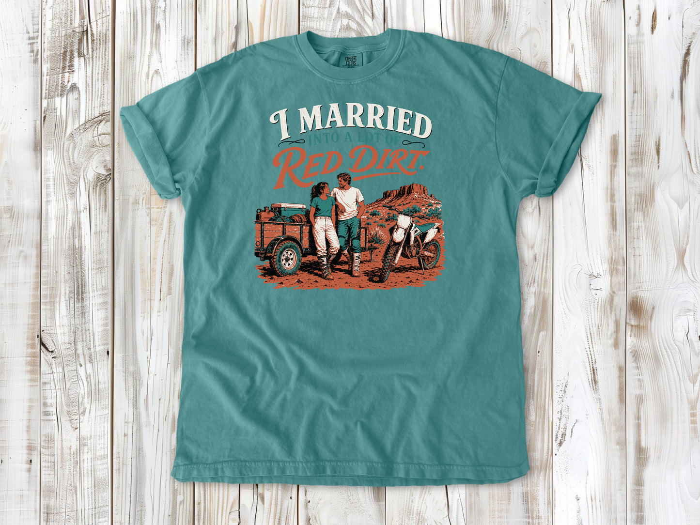 Seafoam garment-dyed tee with I Married Into a Lot of Red Dirt motocross couple graphic.