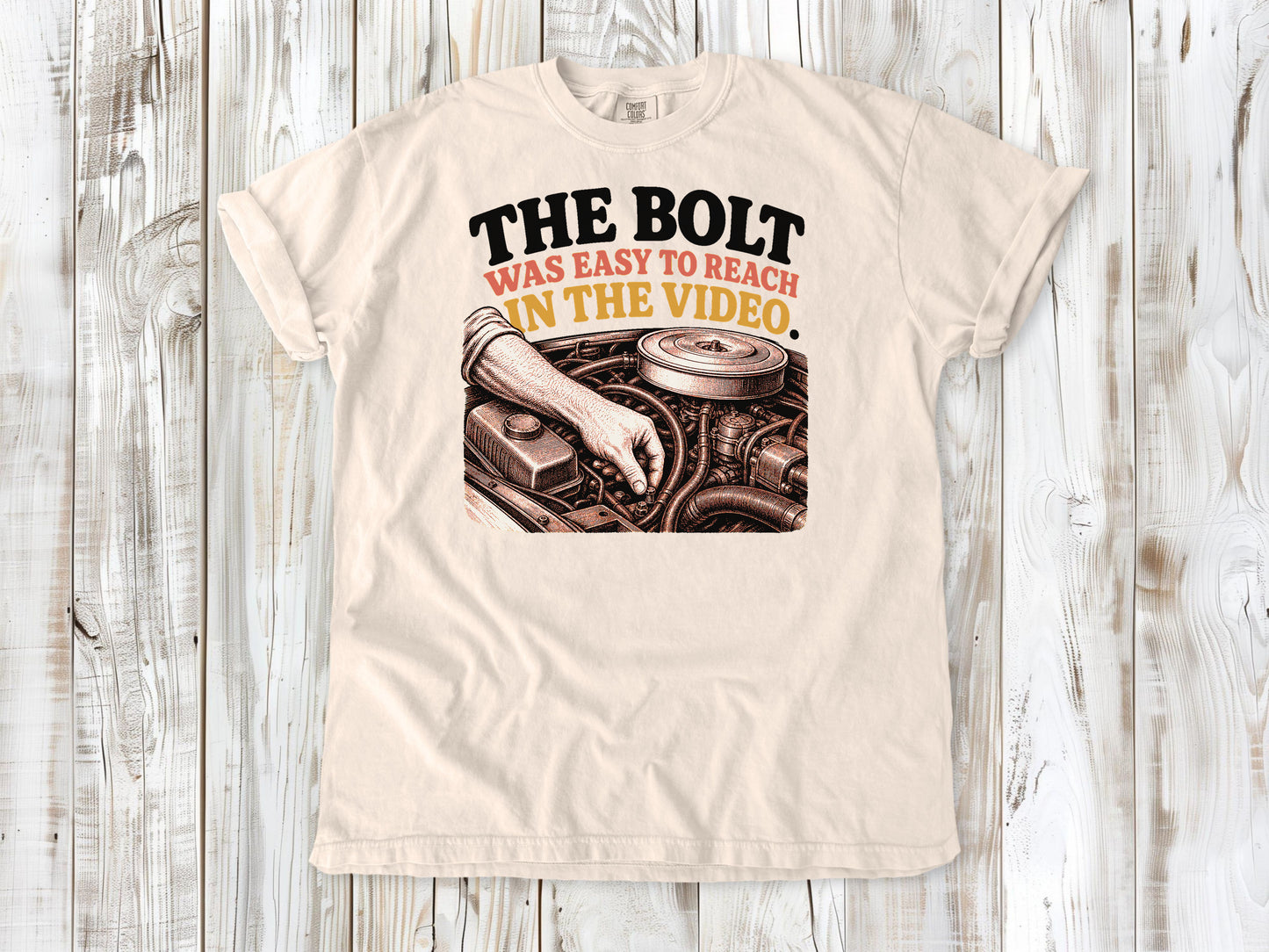 Ivory garment-dyed tee with The Bolt Was Easy to Reach in the Video mechanic graphic.