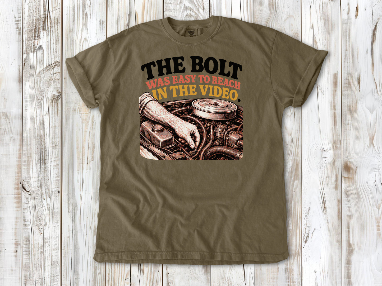 Khaki garment-dyed tee with The Bolt Was Easy to Reach in the Video mechanic graphic.
