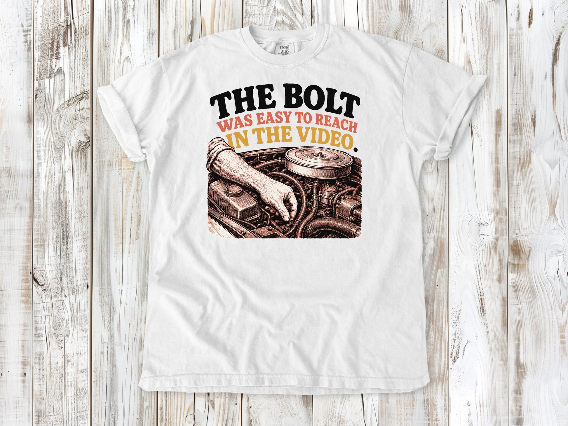 White garment-dyed tee with The Bolt Was Easy to Reach in the Video mechanic graphic.