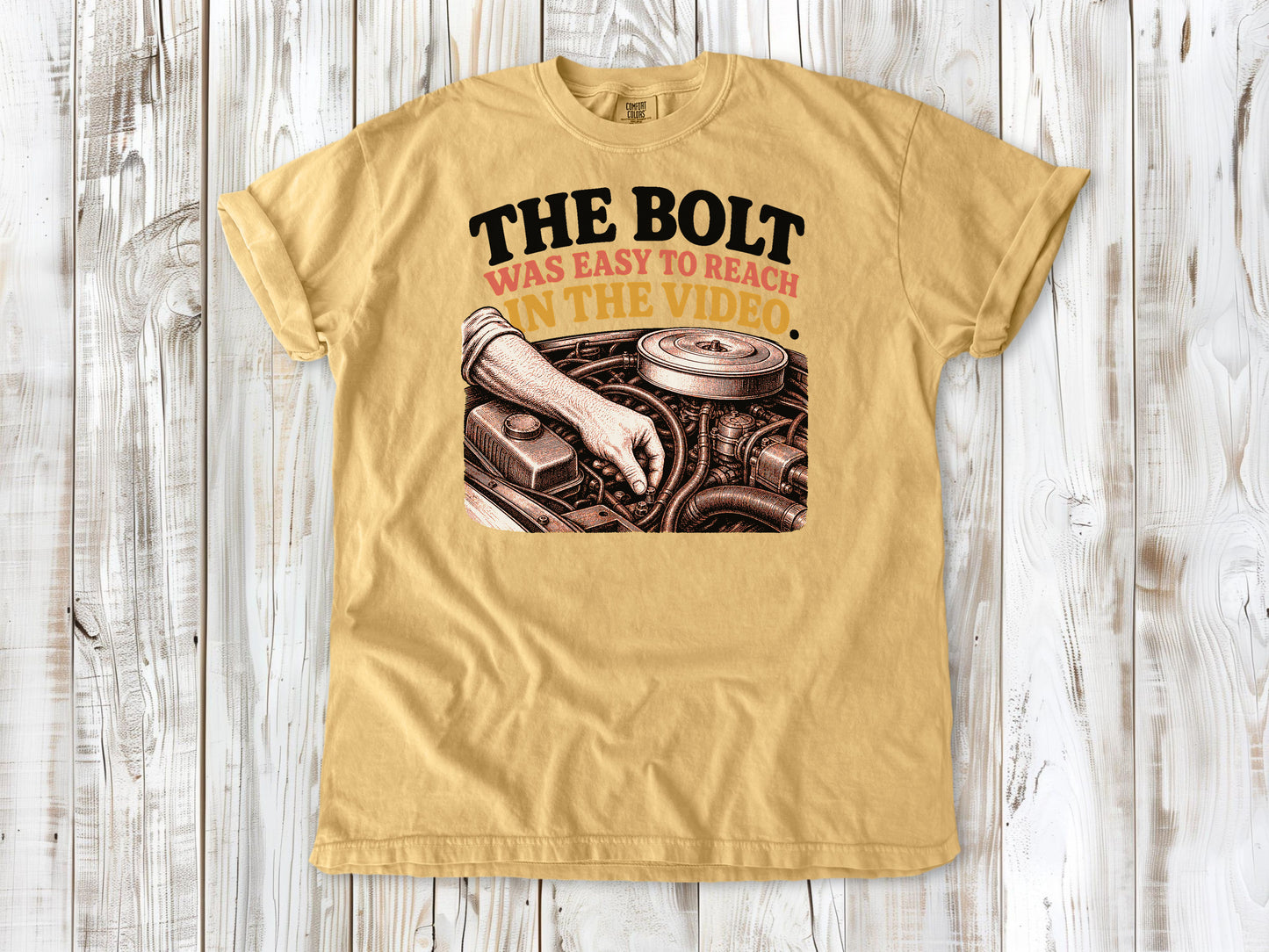 Mustard garment-dyed tee with The Bolt Was Easy to Reach in the Video mechanic graphic.