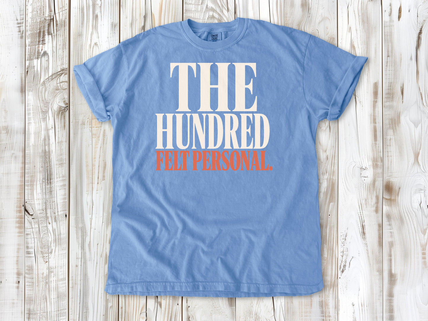 Washed Denim garment-dyed tee with The Hundred Felt Personal Pilates exercise graphic.