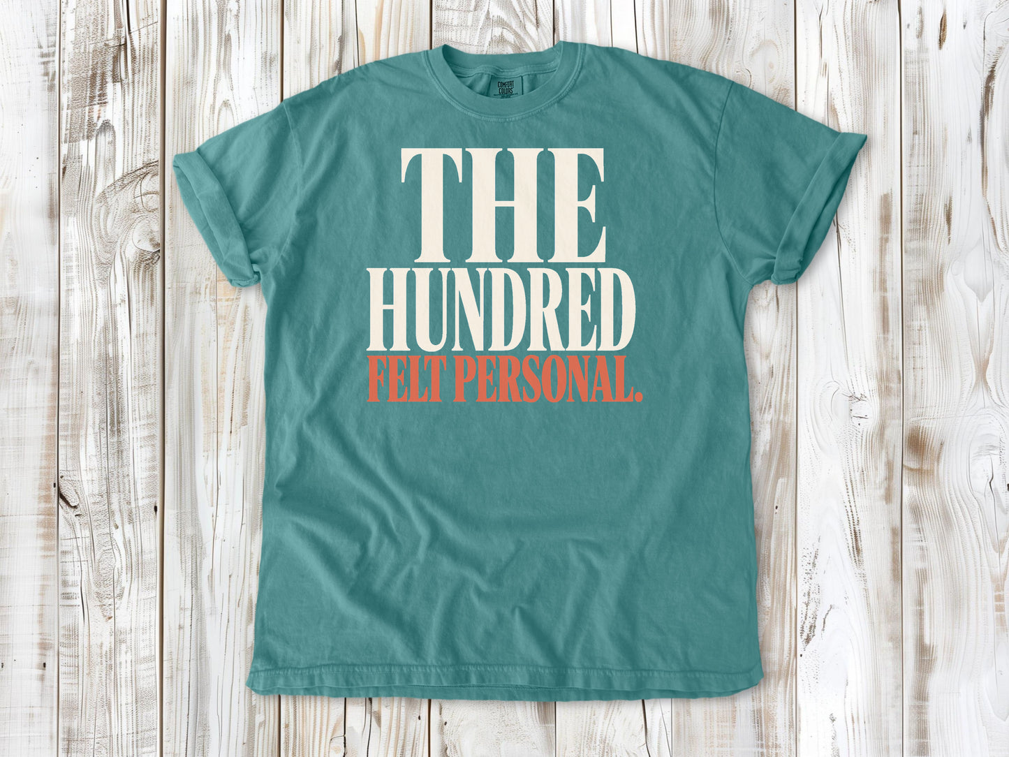 Seafoam garment-dyed tee with The Hundred Felt Personal Pilates exercise graphic.