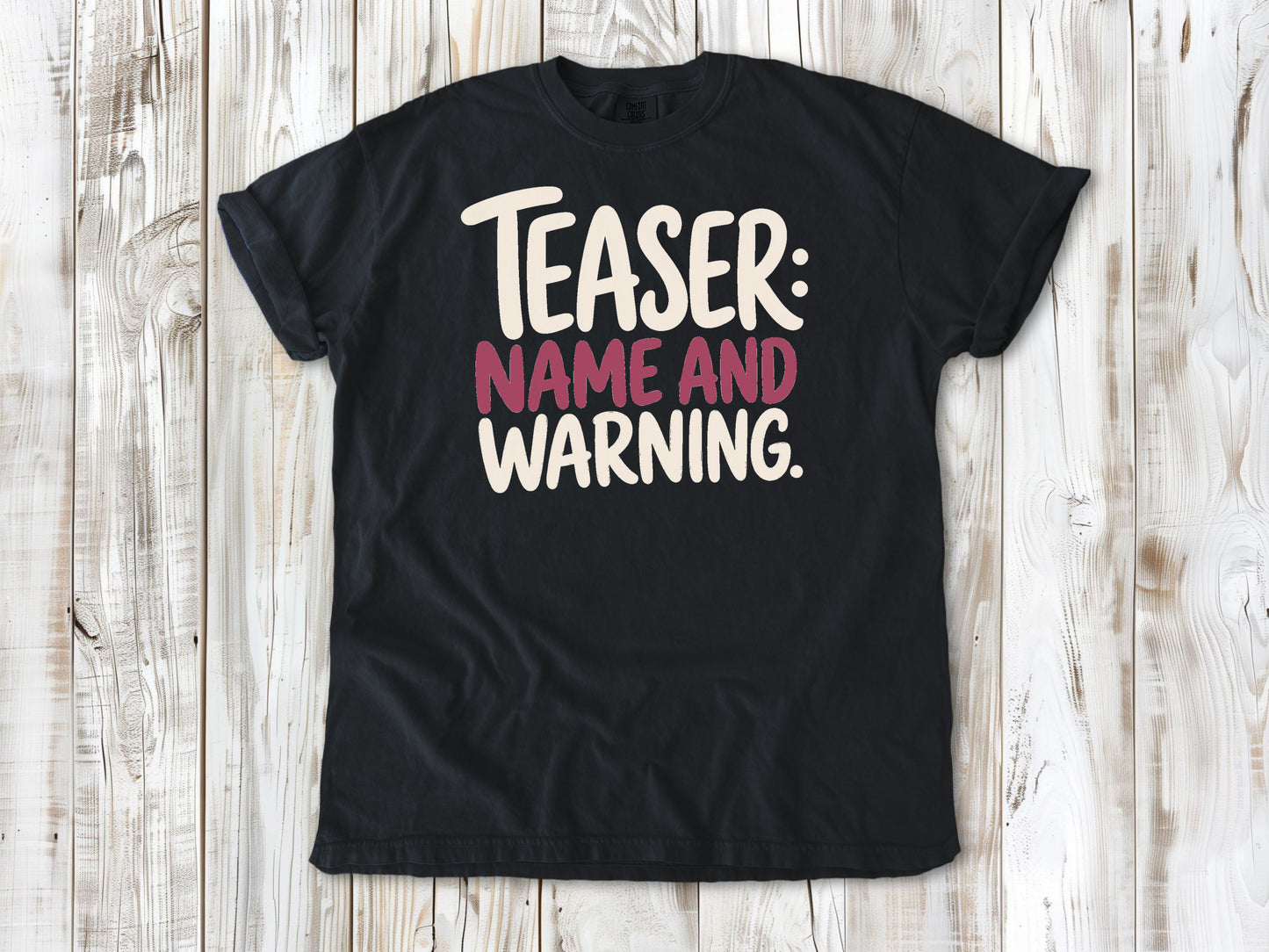 Graphite garment-dyed tee with Teaser Name and Warning Pilates exercise graphic.
