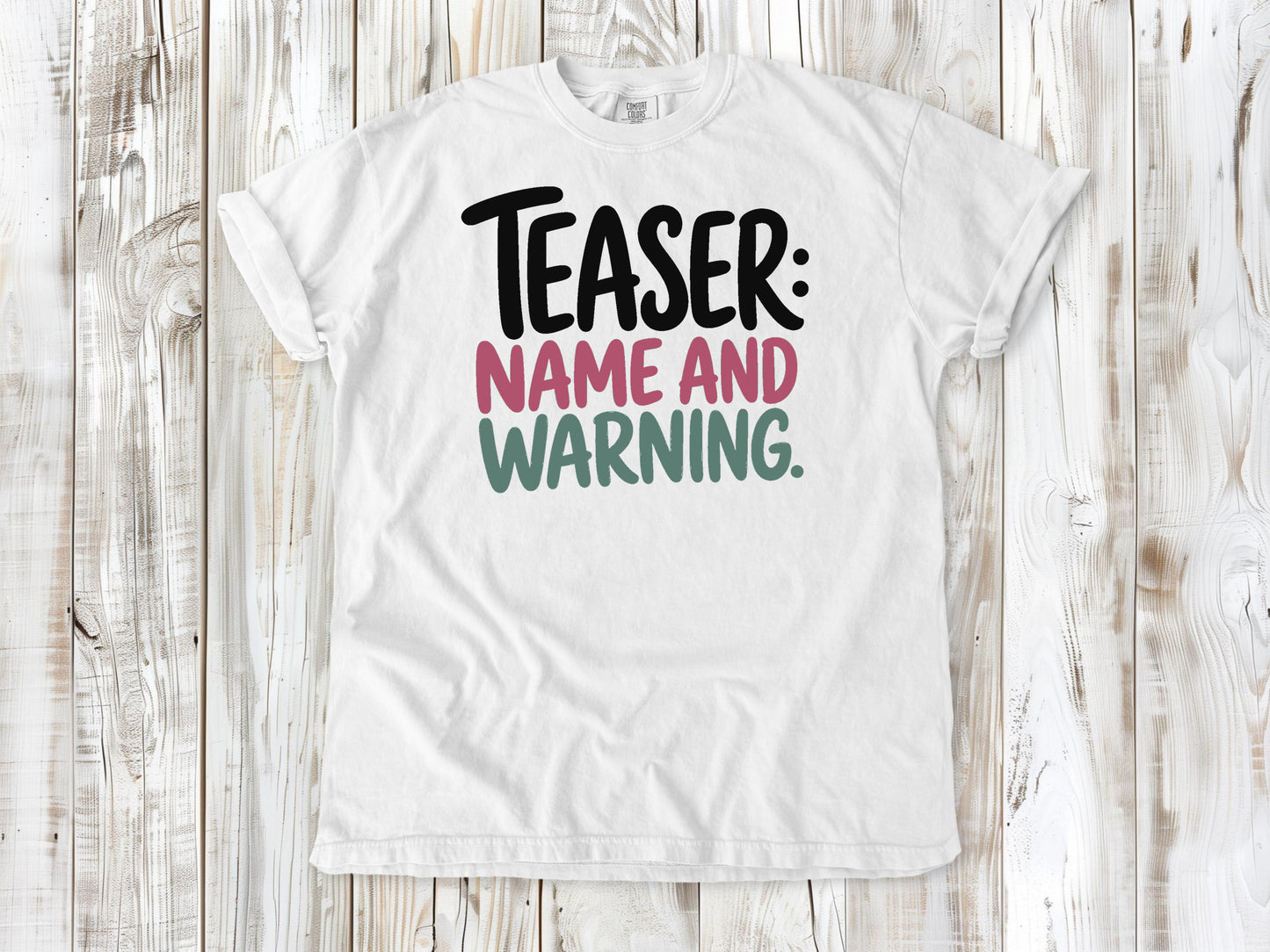 White garment-dyed tee with Teaser Name and Warning Pilates exercise graphic.