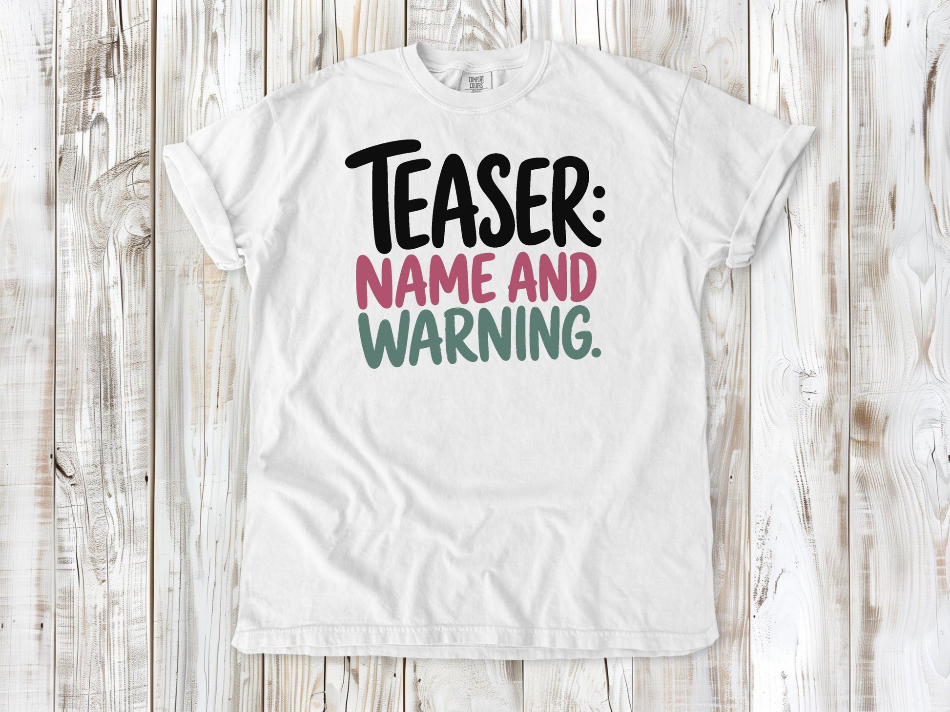 White garment-dyed tee with Teaser Name and Warning Pilates exercise graphic.
