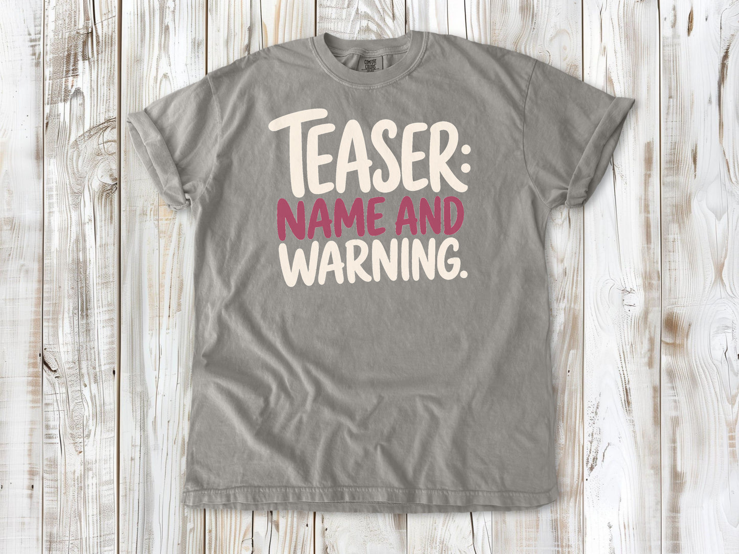 Grey garment-dyed tee with Teaser Name and Warning Pilates exercise graphic.