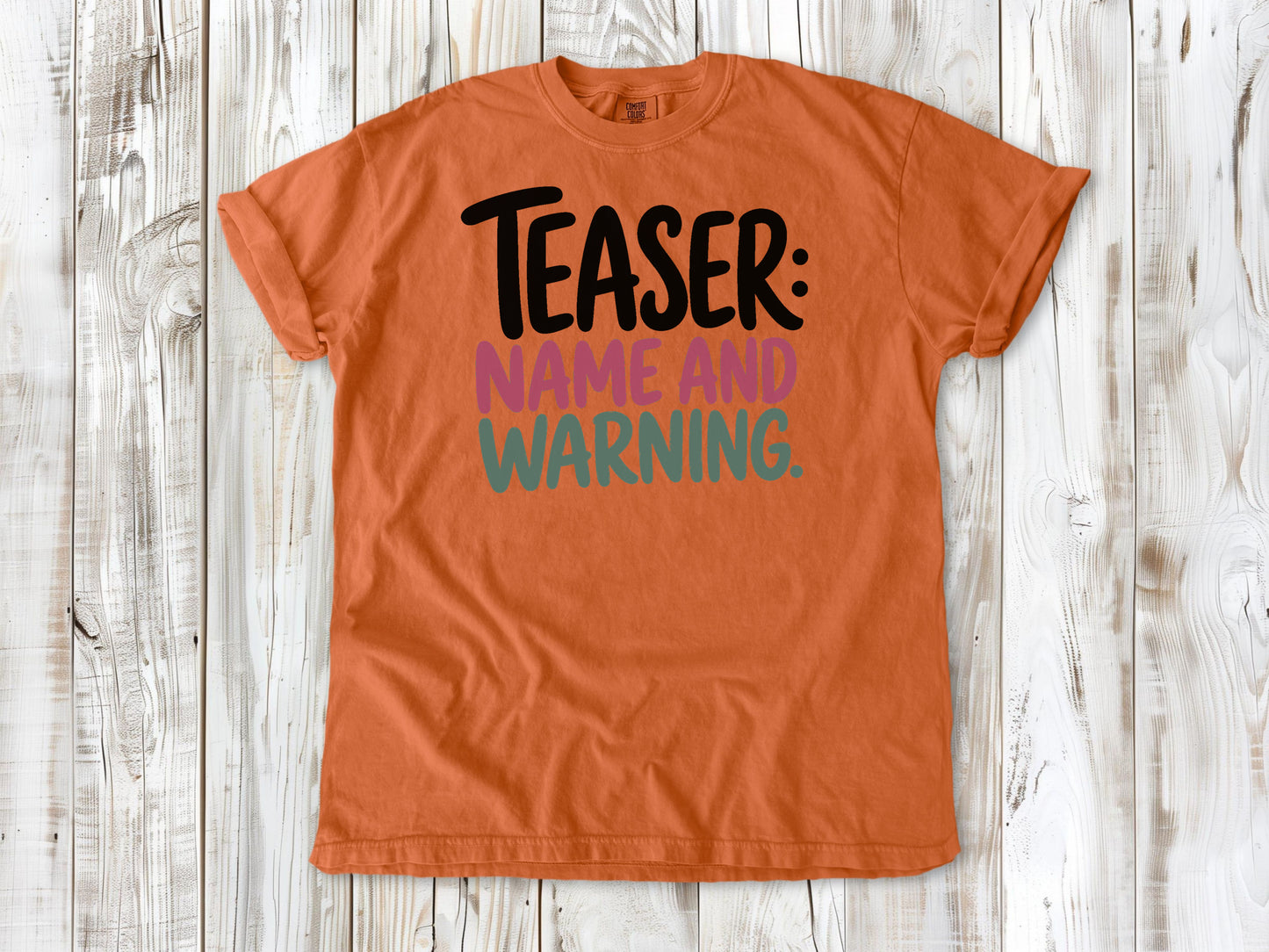 Burnt Orange garment-dyed tee with Teaser Name and Warning Pilates exercise graphic.