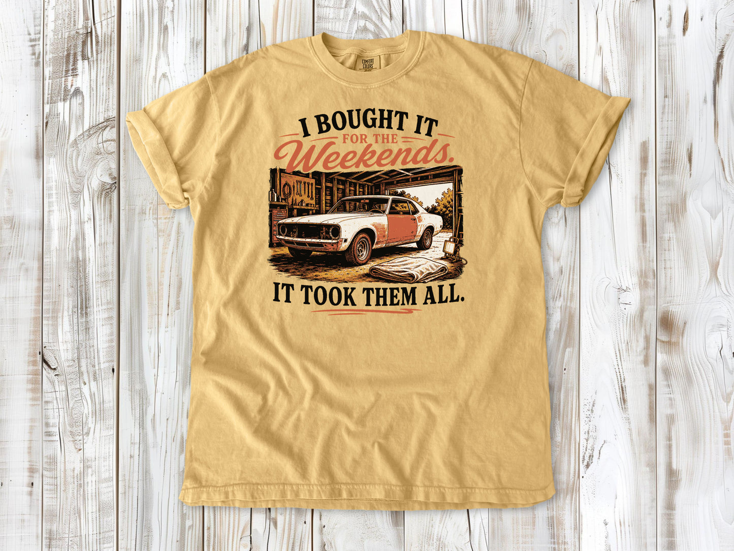 Mustard garment-dyed tee with I Bought It for the Weekends It Took Them All project car graphic.