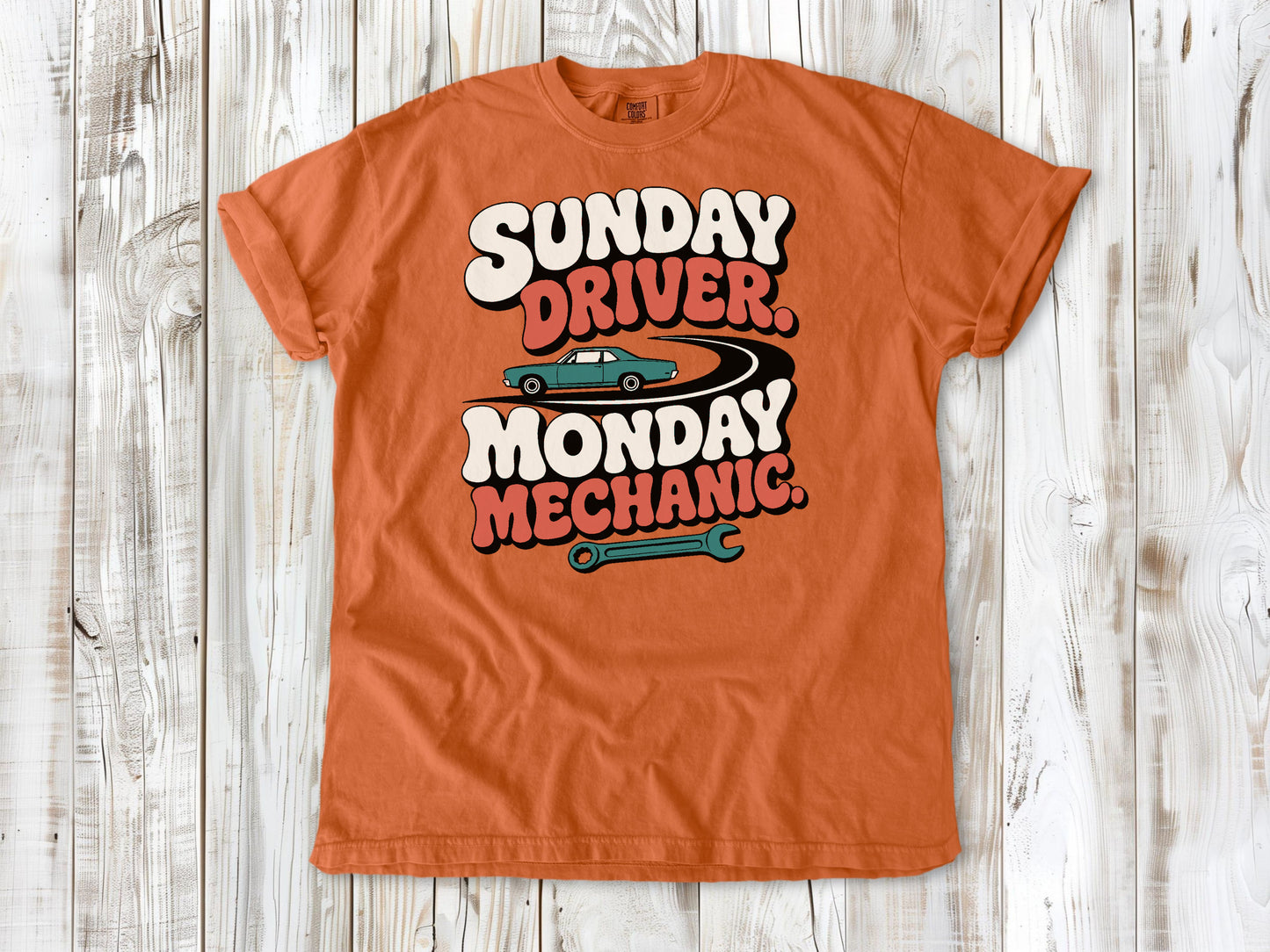 Burnt Orange garment-dyed tee with Sunday Driver Monday Mechanic classic car graphic.