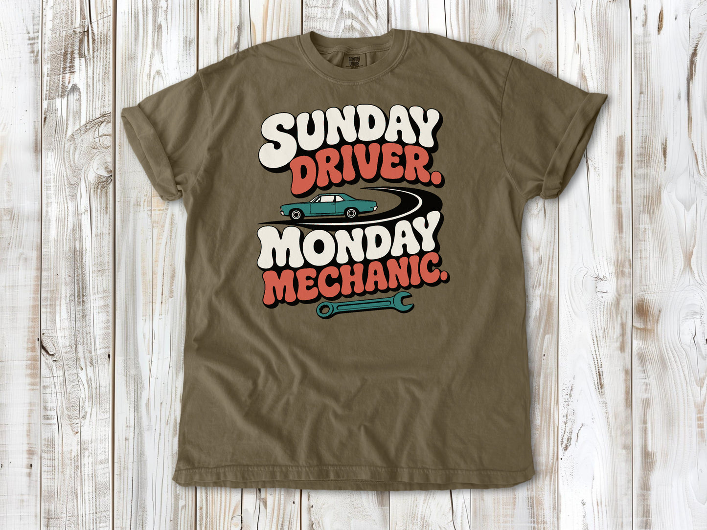 Khaki garment-dyed tee with Sunday Driver Monday Mechanic classic car graphic.