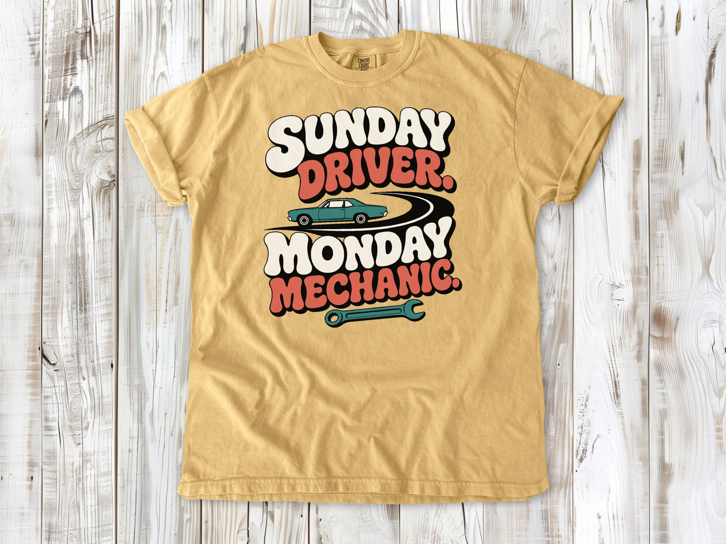 Mustard garment-dyed tee with Sunday Driver Monday Mechanic classic car graphic.