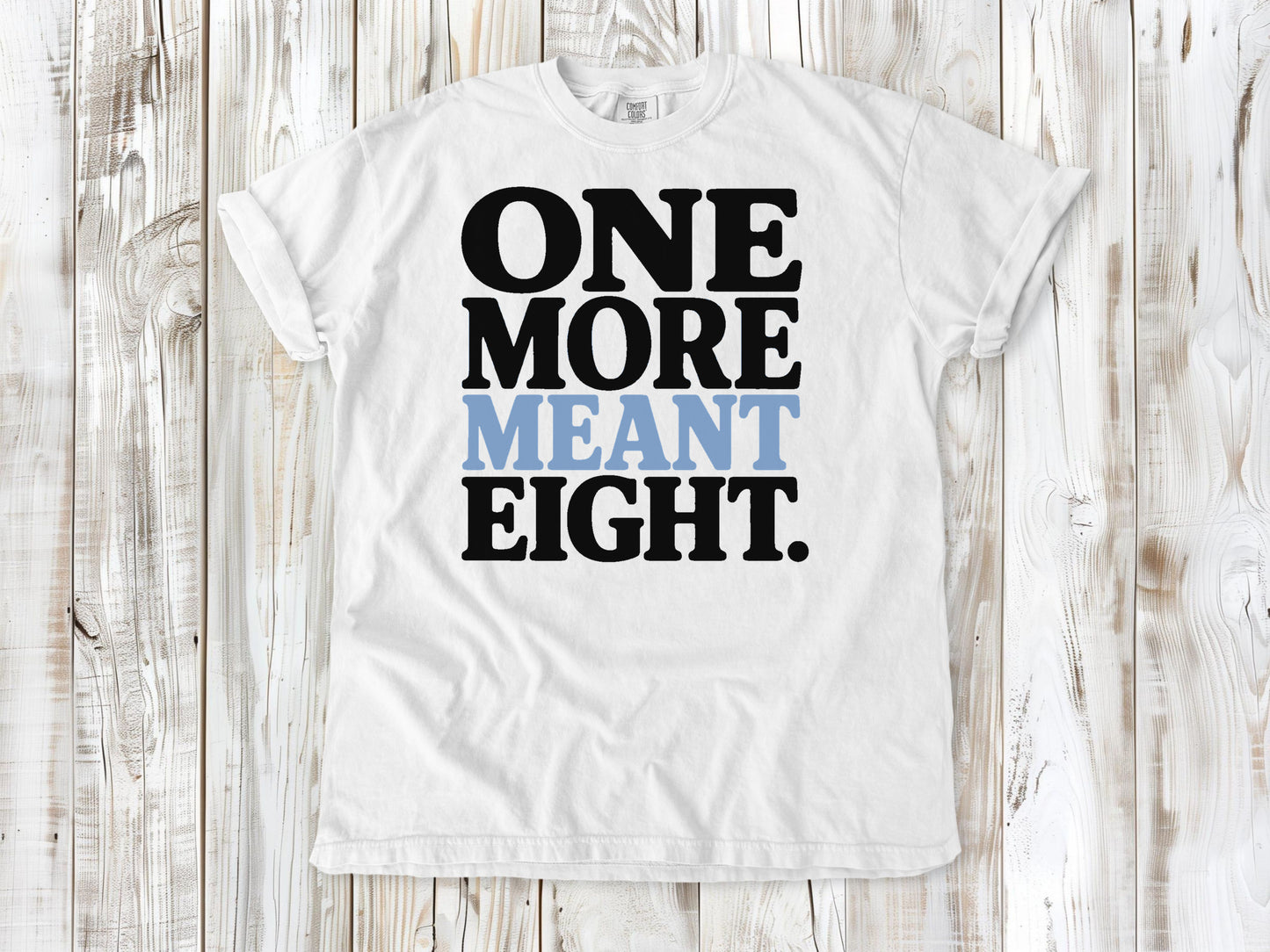 White garment-dyed tee with One More Meant Eight Pilates studio graphic.