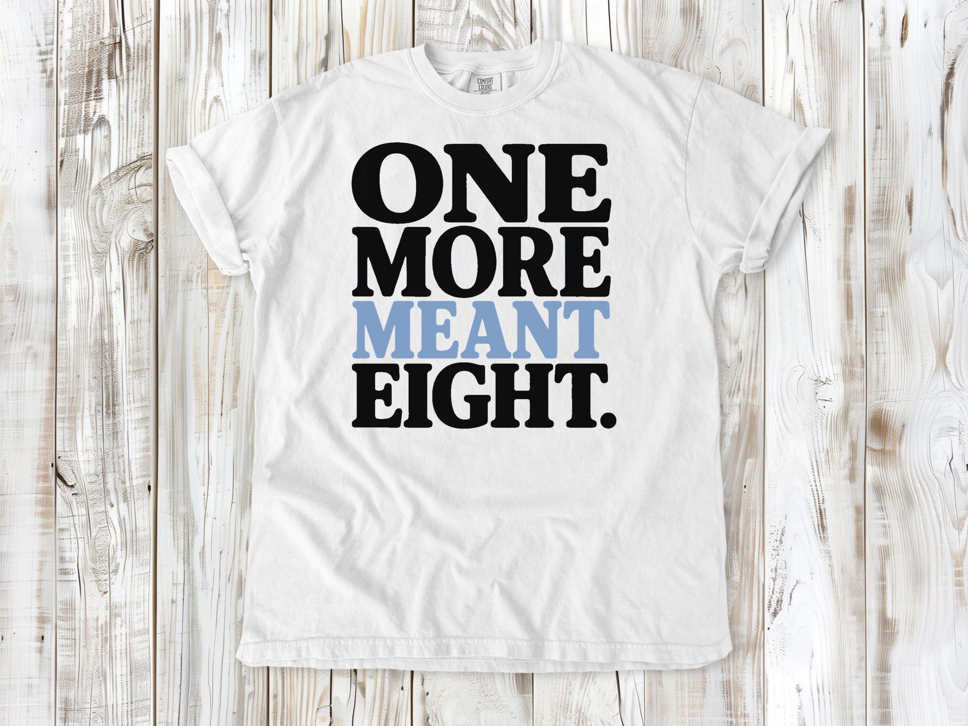White garment-dyed tee with One More Meant Eight Pilates studio graphic.