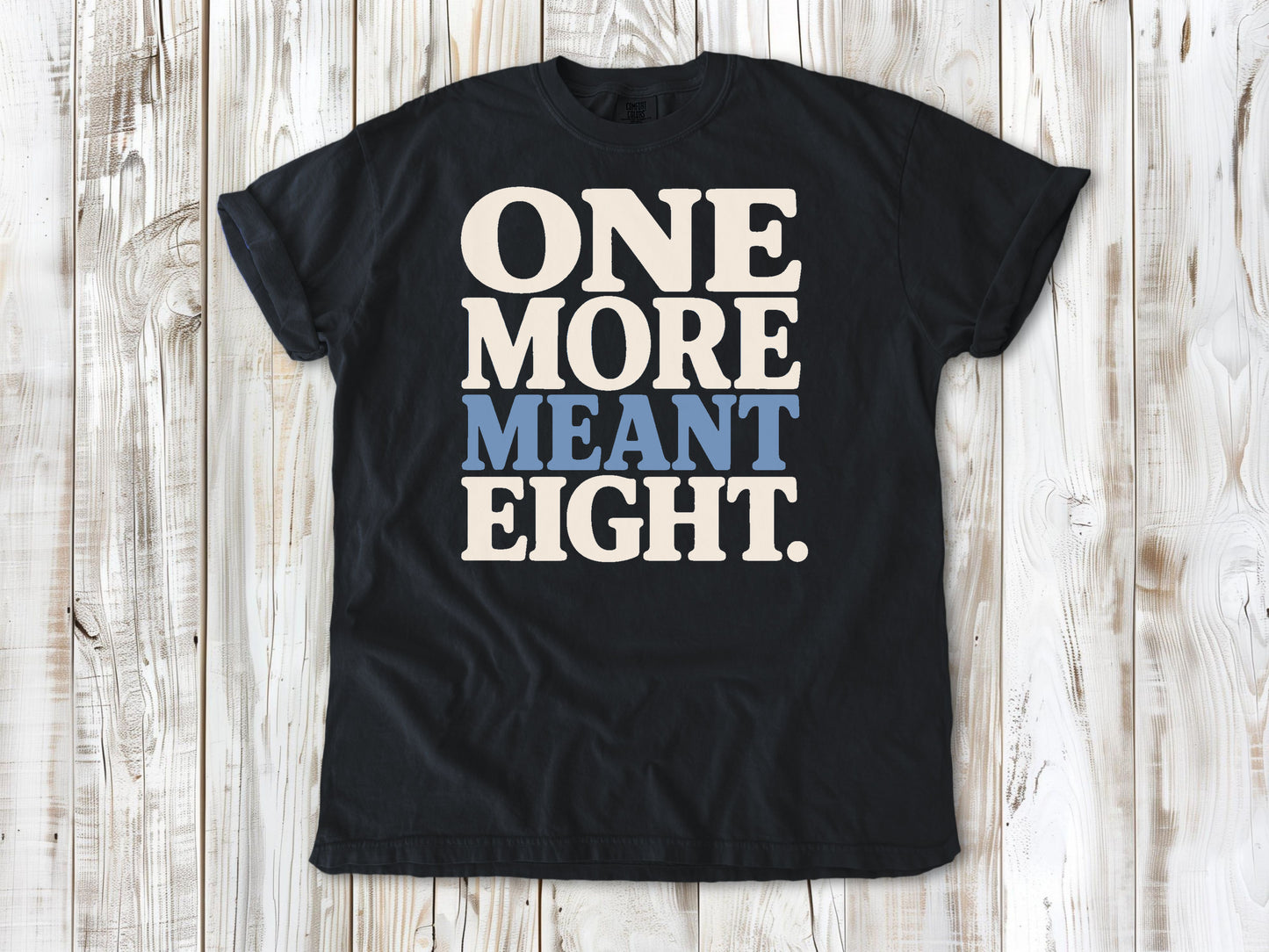 Graphite garment-dyed tee with One More Meant Eight Pilates studio graphic.