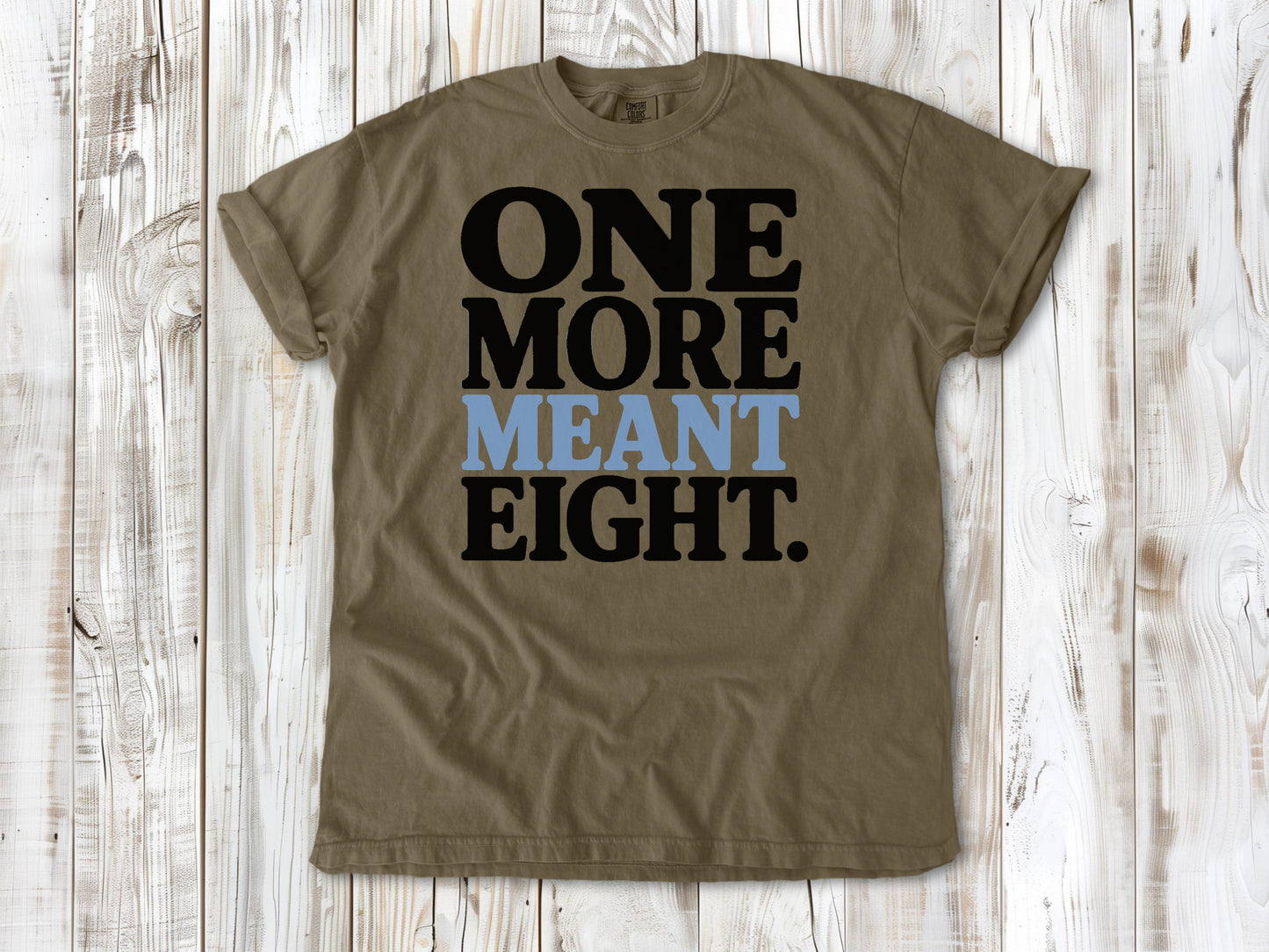 Khaki garment-dyed tee with One More Meant Eight Pilates studio graphic.