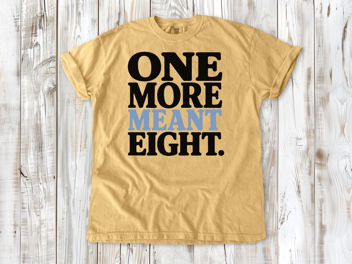 Mustard garment-dyed tee with One More Meant Eight Pilates studio graphic.