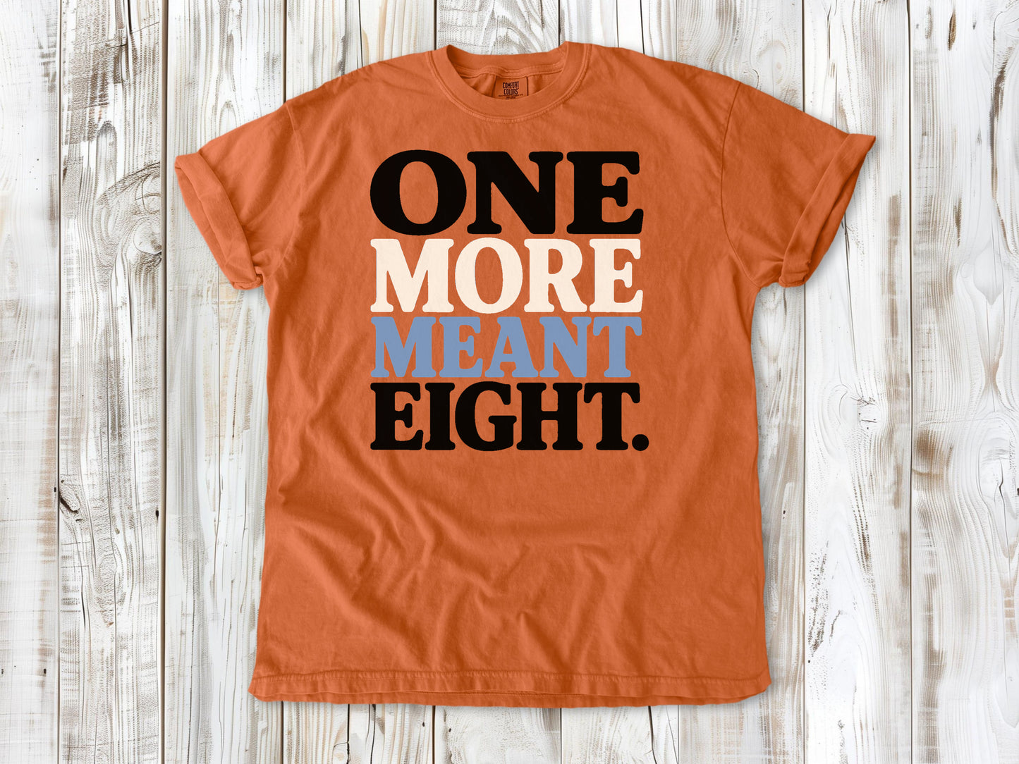 Burnt Orange garment-dyed tee with One More Meant Eight Pilates studio graphic.