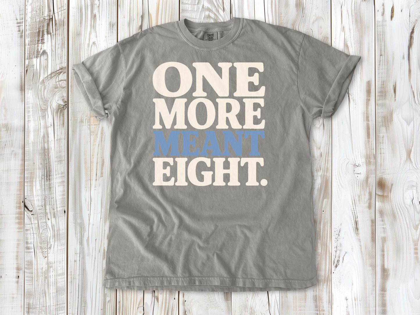 Grey garment-dyed tee with One More Meant Eight Pilates studio graphic.