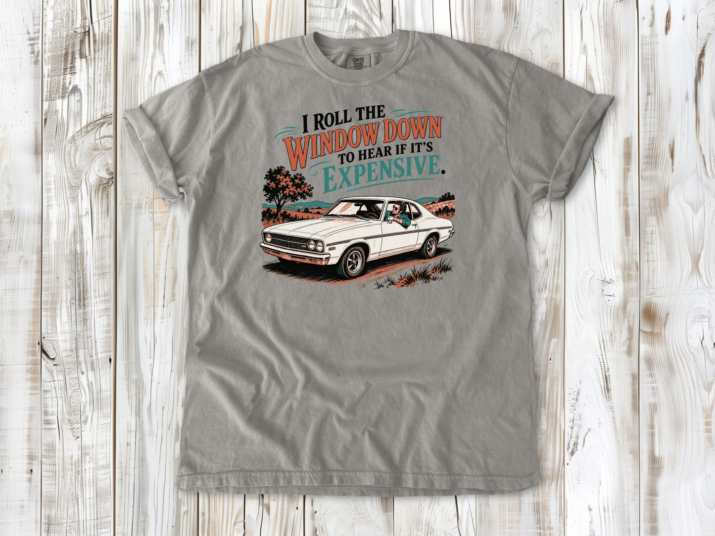 Grey garment-dyed tee with I Roll the Window Down to Hear If It Is Expensive car repair graphic.