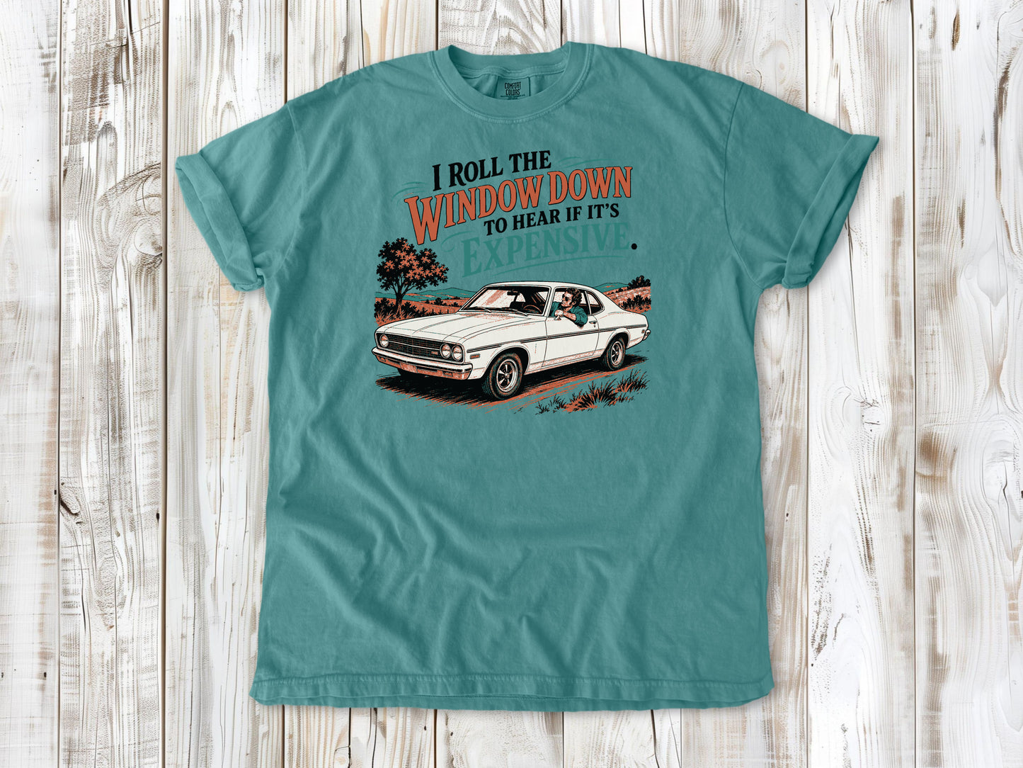 Seafoam garment-dyed tee with I Roll the Window Down to Hear If It Is Expensive car repair graphic.