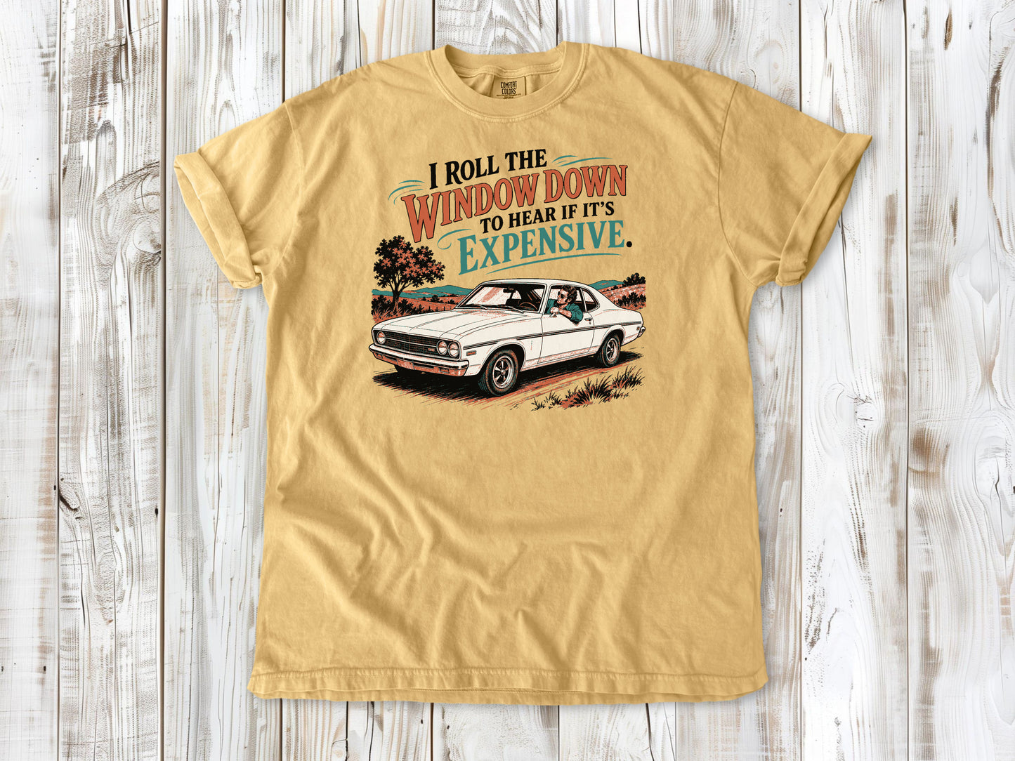 Mustard garment-dyed tee with I Roll the Window Down to Hear If It Is Expensive car repair graphic.