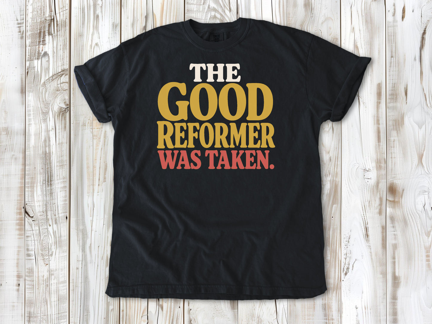 Graphite garment-dyed tee with The Good Reformer Was Taken Pilates studio graphic.