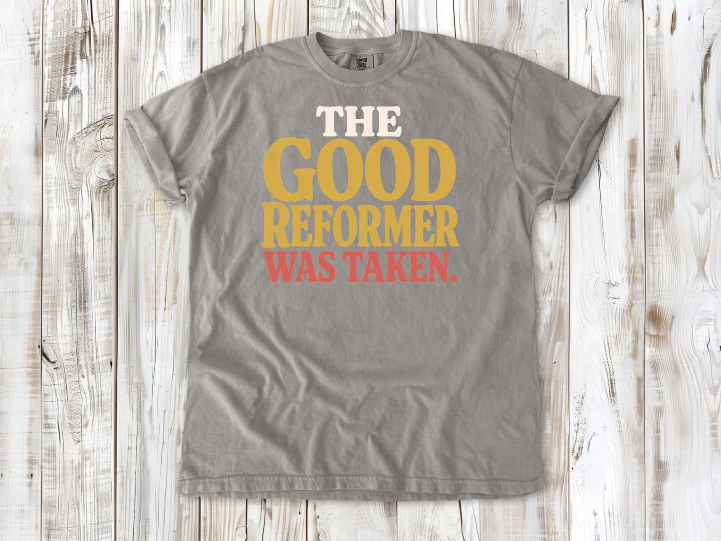 Grey garment-dyed tee with The Good Reformer Was Taken Pilates studio graphic.