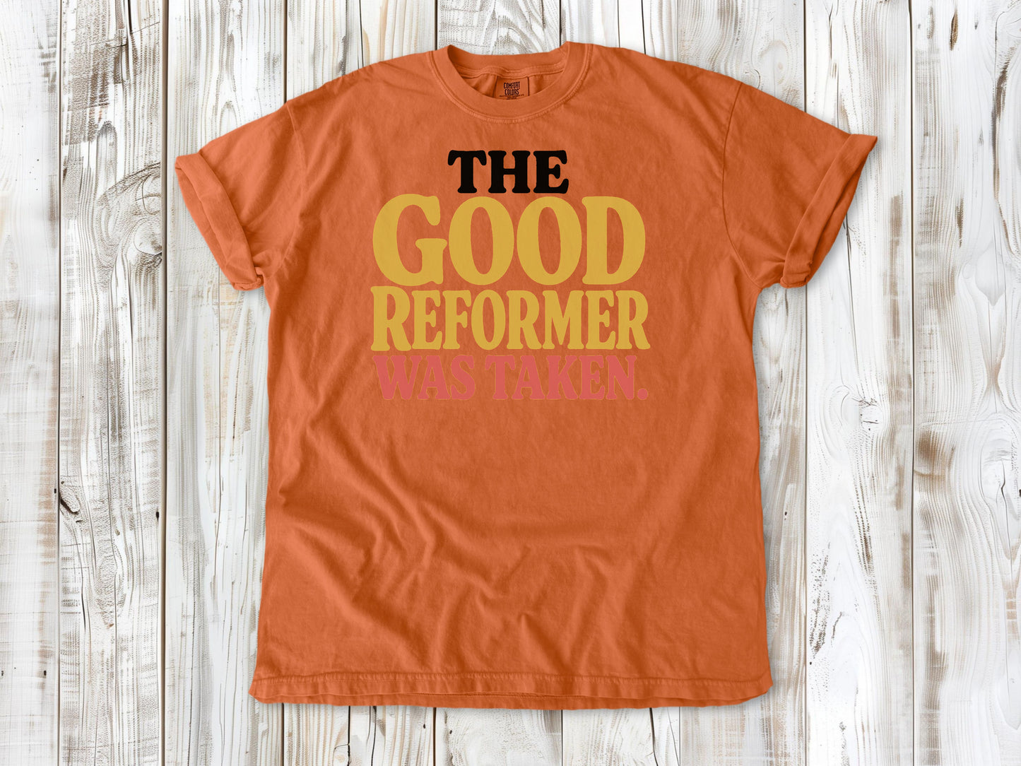 Burnt Orange garment-dyed tee with The Good Reformer Was Taken Pilates studio graphic.